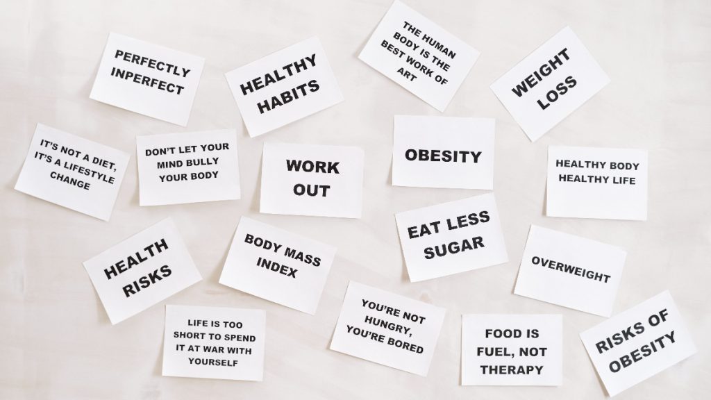 Paper cards displaying assorted messages about diet, exercise, weight and body image.
